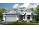 Two-story home with light blue siding, gray roof, and a two-car garage at 5531 Orsello St, Palmetto, FL 34221