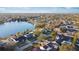 Aerial view of a lakefront home in a residential neighborhood at 6709 Ranger Dr, Tampa, FL 33615