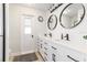 Modern bathroom with double vanity, two mirrors, and a walk-in shower at 6709 Ranger Dr, Tampa, FL 33615