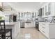 Modern white kitchen with stainless steel appliances and a large island at 6709 Ranger Dr, Tampa, FL 33615