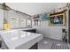Outdoor bar with countertop, cabinets, and framed sports memorabilia at 6709 Ranger Dr, Tampa, FL 33615