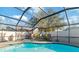 Inviting kidney shaped pool with a screened enclosure at 6709 Ranger Dr, Tampa, FL 33615