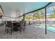 Outdoor dining area with a fire table and pool view at 6709 Ranger Dr, Tampa, FL 33615