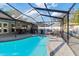 Inviting swimming pool with covered patio and seating area at 6709 Ranger Dr, Tampa, FL 33615