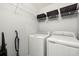 Laundry room with washer, dryer, and shelving at 7001 Interbay Blvd # 313, Tampa, FL 33616