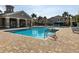 Community pool with lounge chairs and a clubhouse in the background at 7001 Interbay Blvd # 313, Tampa, FL 33616