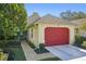 Cute Florida home with red garage door and landscaped yard at 8308 Antigua Ct, Port Richey, FL 34668