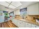 Well-equipped kitchen featuring granite counters and white cabinets at 8308 Antigua Ct, Port Richey, FL 34668