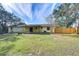 Spacious backyard with a large grassy area and a new fence at 9650 Starline Dr, Dade City, FL 33525