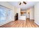 Living room with wood floors, ceiling fan and kitchen access at 9650 Starline Dr, Dade City, FL 33525