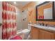 Bathroom with shower/tub combo and colorful shower curtain at 10126 Londonshire Ln, Tampa, FL 33647