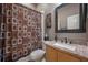 Clean bathroom with shower, toilet, and granite countertop at 10126 Londonshire Ln, Tampa, FL 33647
