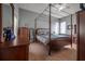 Bedroom with a four-poster bed and wood furniture at 10126 Londonshire Ln, Tampa, FL 33647
