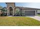One-story house with a large front yard and palm trees at 10126 Londonshire Ln, Tampa, FL 33647