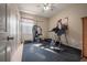 Home gym with treadmill, weight machine and exercise mat at 10126 Londonshire Ln, Tampa, FL 33647