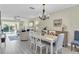 Elegant dining room with a chandelier and white table and chairs at 1035 Dunrobin Dr # C, Palm Harbor, FL 34684