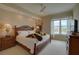 Comfortable bedroom with a king-size bed and water views at 10520 Boardwalk Loop # 503, Bradenton, FL 34202