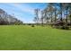 Open grassy backyard with a shaded pavilion at 10813 Dixon Dr, Riverview, FL 33579