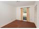 Simple bedroom with brown carpet, window, and closet at 10813 Dixon Dr, Riverview, FL 33579