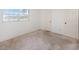 Simple bedroom with neutral carpeting and large window at 10813 Dixon Dr, Riverview, FL 33579