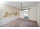 Bright dining room with a chandelier, wall mural, and carpeted floors at 10813 Dixon Dr, Riverview, FL 33579
