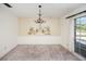 Charming dining room with a chandelier, wall mural, and carpeted floors at 10813 Dixon Dr, Riverview, FL 33579