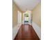 Bright entryway with wood-look tile floor and gold wallpaper at 10813 Dixon Dr, Riverview, FL 33579