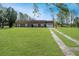 Brick ranch house with a large yard and a long driveway at 10813 Dixon Dr, Riverview, FL 33579