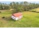 Detached garage with red doors and white exterior at 10813 Dixon Dr, Riverview, FL 33579