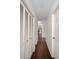 Hallway with wood-look tile floors, leading to other rooms at 10813 Dixon Dr, Riverview, FL 33579