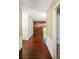 Long hallway with wood-look tile floor and gold wallpaper at 10813 Dixon Dr, Riverview, FL 33579