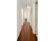 Long hallway with wood-look tile flooring and built-in storage at 10813 Dixon Dr, Riverview, FL 33579
