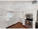 Bright kitchen with white cabinets, stainless steel appliances, and tile flooring at 10813 Dixon Dr, Riverview, FL 33579