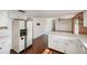 Kitchen with white cabinets, tile floor and view of living room at 10813 Dixon Dr, Riverview, FL 33579