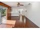 Living room with wood-paneled wall, tile floor and access to kitchen at 10813 Dixon Dr, Riverview, FL 33579
