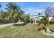 House with palm trees, driveway and small front yard at 11435 2Nd E St, Treasure Island, FL 33706