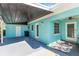 Light teal house exterior with covered patio and spacious backyard at 11435 2Nd E St, Treasure Island, FL 33706