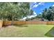Backyard with wooden fence and large tree at 11505 Blackbark Dr, Riverview, FL 33579
