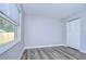 Spacious bedroom with grey walls, wood-look floors, and large window at 11505 Blackbark Dr, Riverview, FL 33579