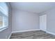 Spacious bedroom with wood-look floors and window with blinds at 11505 Blackbark Dr, Riverview, FL 33579