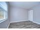 Simple bedroom with neutral walls, wood-look floors, and closet at 11505 Blackbark Dr, Riverview, FL 33579