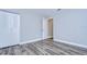 Bright bedroom with wood-look floors and double door closet at 11505 Blackbark Dr, Riverview, FL 33579
