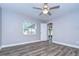 Bright bedroom with ceiling fan and wood-look flooring at 11505 Blackbark Dr, Riverview, FL 33579