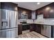 Modern kitchen with stainless steel appliances and dark cabinets at 11505 Blackbark Dr, Riverview, FL 33579