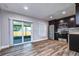 Modern kitchen with dark cabinets, stainless steel appliances, and wood floors at 11505 Blackbark Dr, Riverview, FL 33579