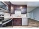 Kitchen with dark wood cabinets, stainless steel appliances, and a tile backsplash at 11505 Blackbark Dr, Riverview, FL 33579