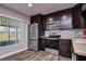 Updated kitchen featuring stainless steel appliances and dark cabinetry at 11505 Blackbark Dr, Riverview, FL 33579