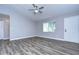 Living room featuring light grey walls, wood-look floors, and a ceiling fan at 11505 Blackbark Dr, Riverview, FL 33579