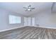 Living room with wood-look floors and a ceiling fan; neutral decor at 11505 Blackbark Dr, Riverview, FL 33579