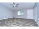 Bright living room with grey walls, wood-look floors, and ceiling fan at 11505 Blackbark Dr, Riverview, FL 33579